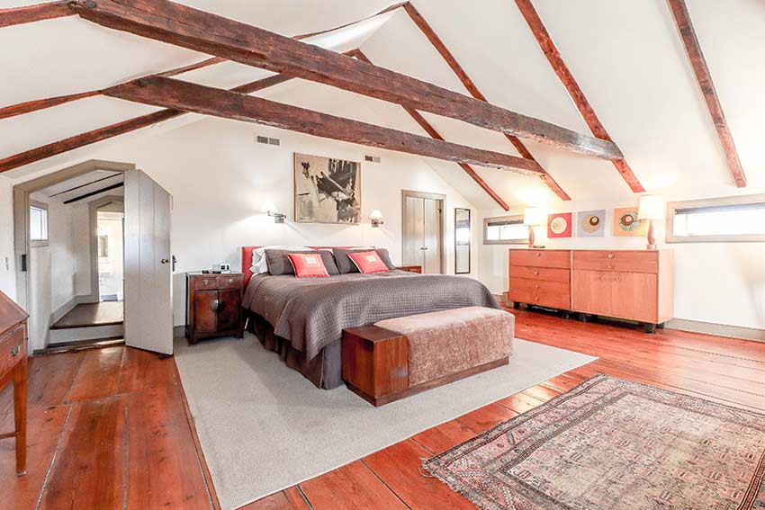 Primary bedroom with exposed wood beams