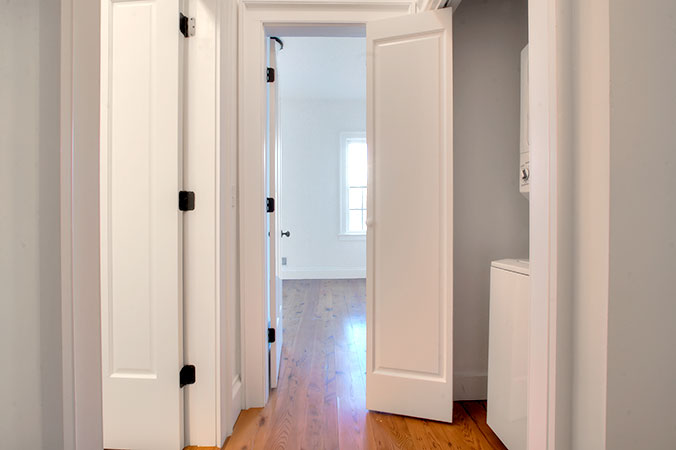 Hallway with washer and dryer in a closet