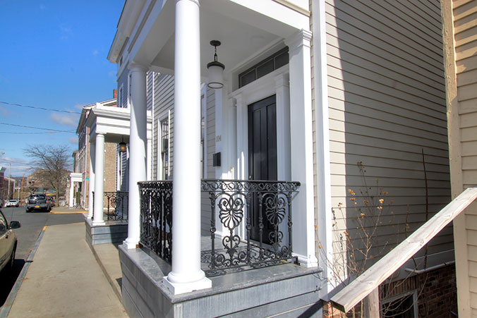 Small covered front porch with white columns