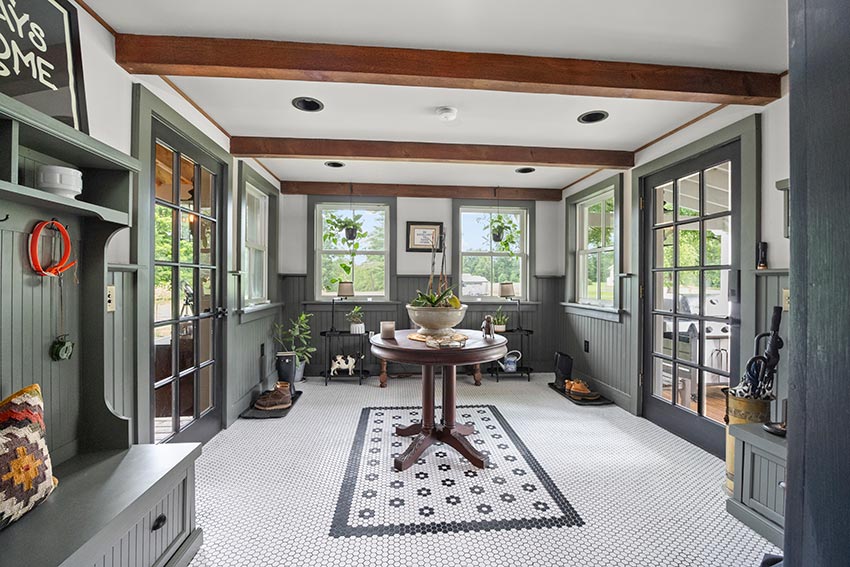 Tiled room with windows, doors to porches