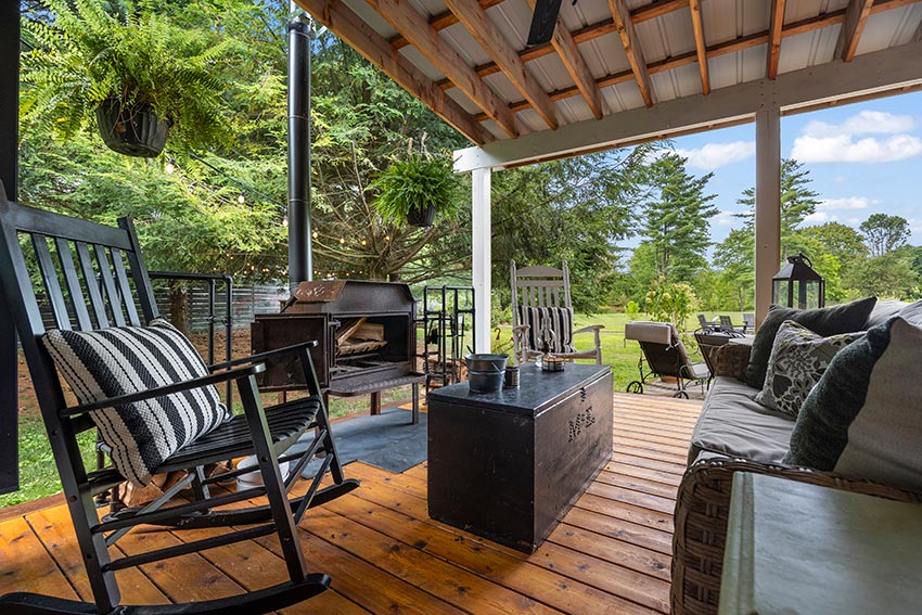 Covered porch with a wood stove fireplace & seating area