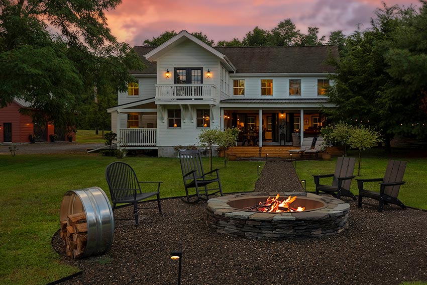 The outdoor space features a bluestone patio, fire pit, enclosed lighted garden