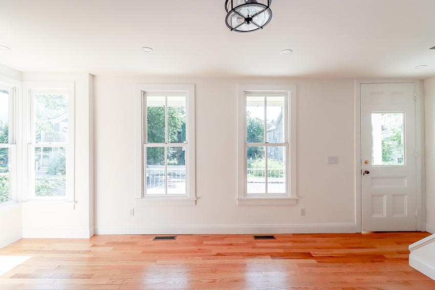 Hardwood floors and windows in the living room.