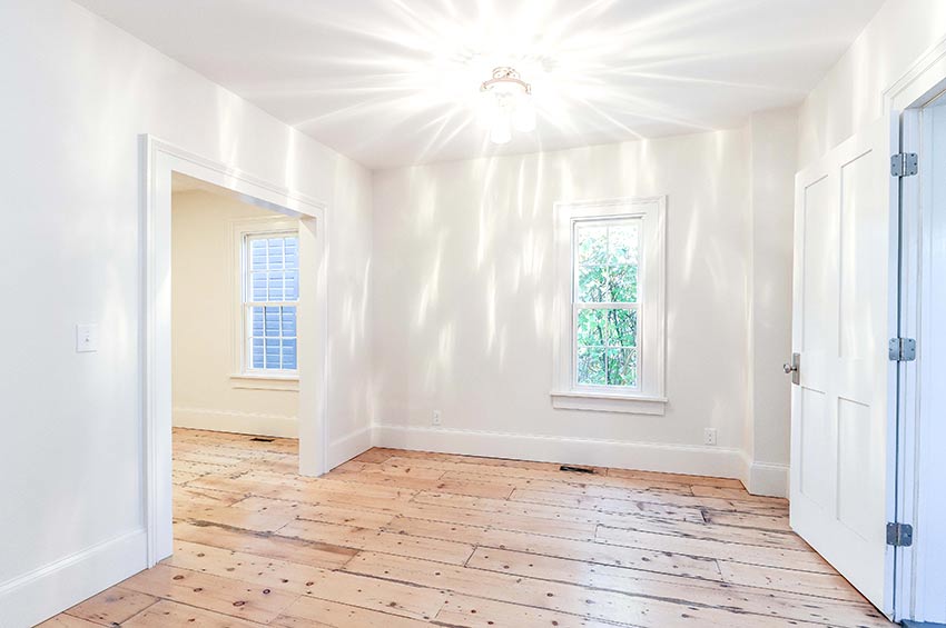 Light filled bedroom with hardwood floors