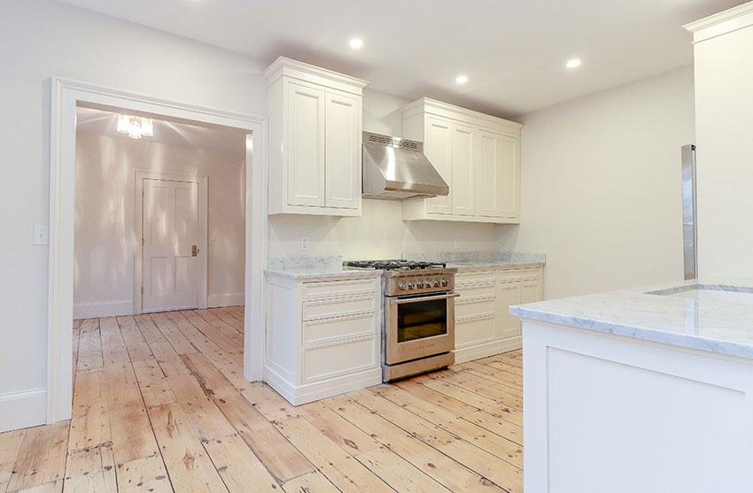 Kitchen with custom built solid wood cabinetry, honed marble counters & stainless steel appliances.