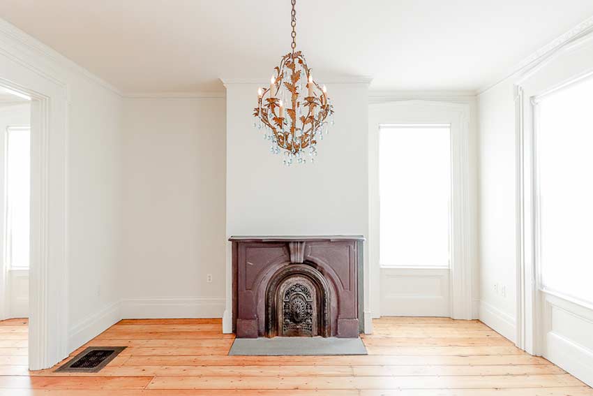 Cast-iron & stone fireplace in front parlor.