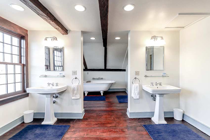 Bathroom featuring claw foot bathing tub and dual sinks