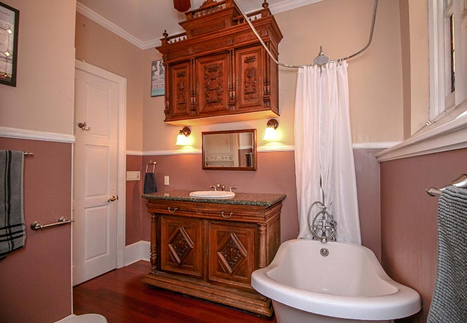 Bathroom with ornate woodwork and tub