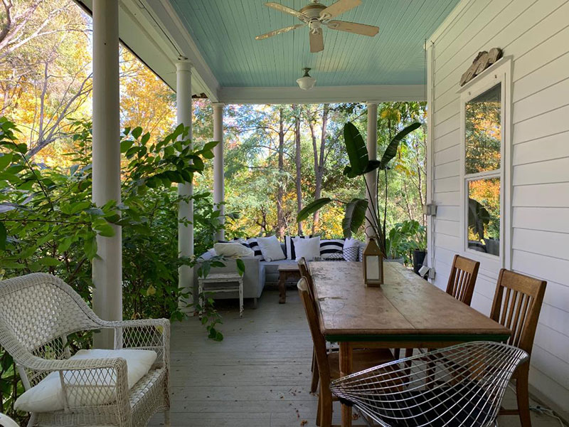 Covered porch with table and chairs