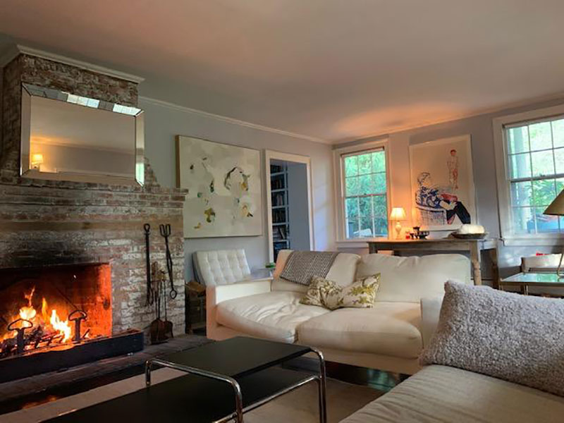 Living room with original brick wood burning fireplace