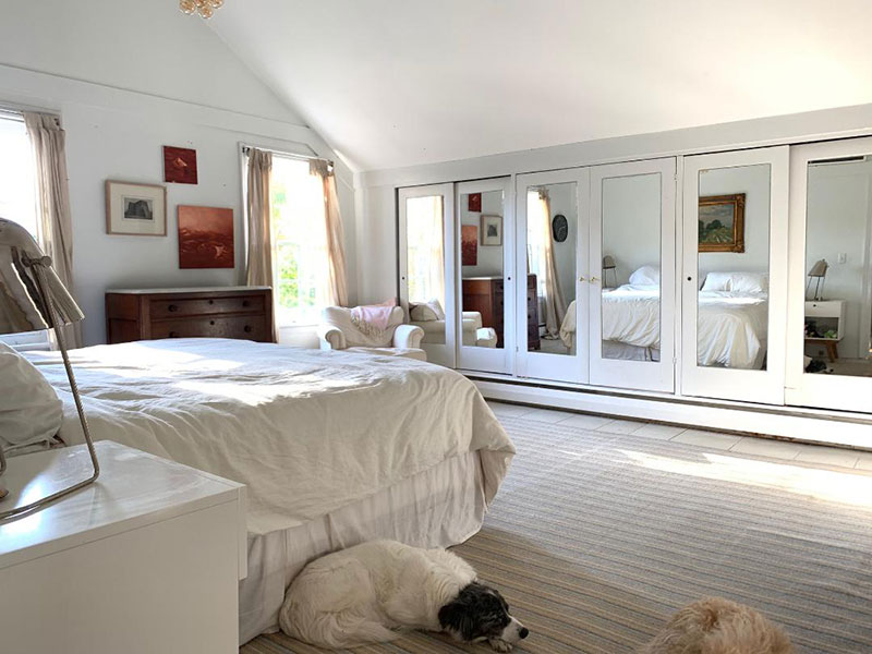 Bedroom with mirrored sliding closet doors