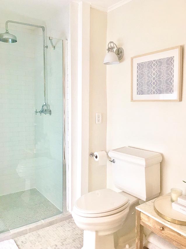 A newly tiled bathroom with glassed-in, walk-in shower