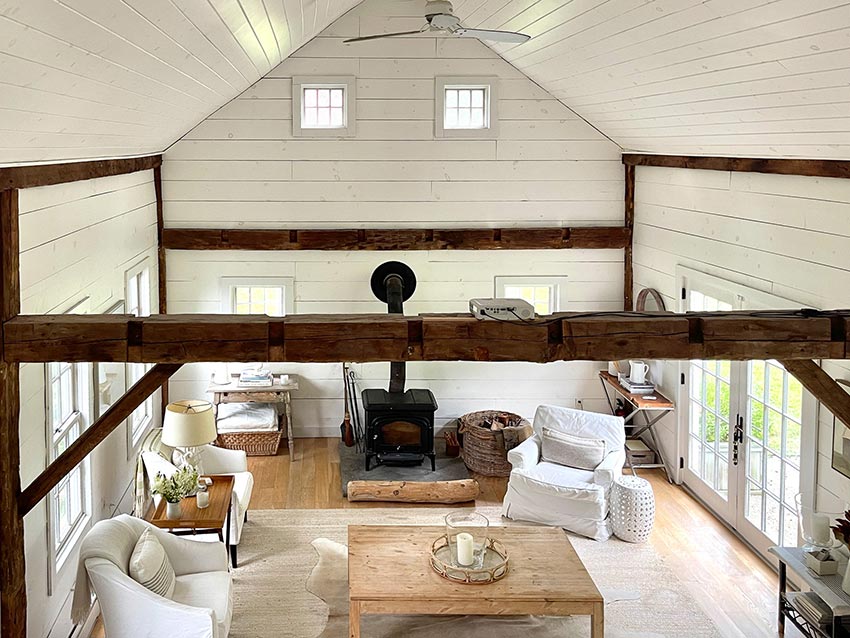 18ft ceilings & an open floor plan combines living room with a wood burning stove & a sleeping loft with skylights that accommodate